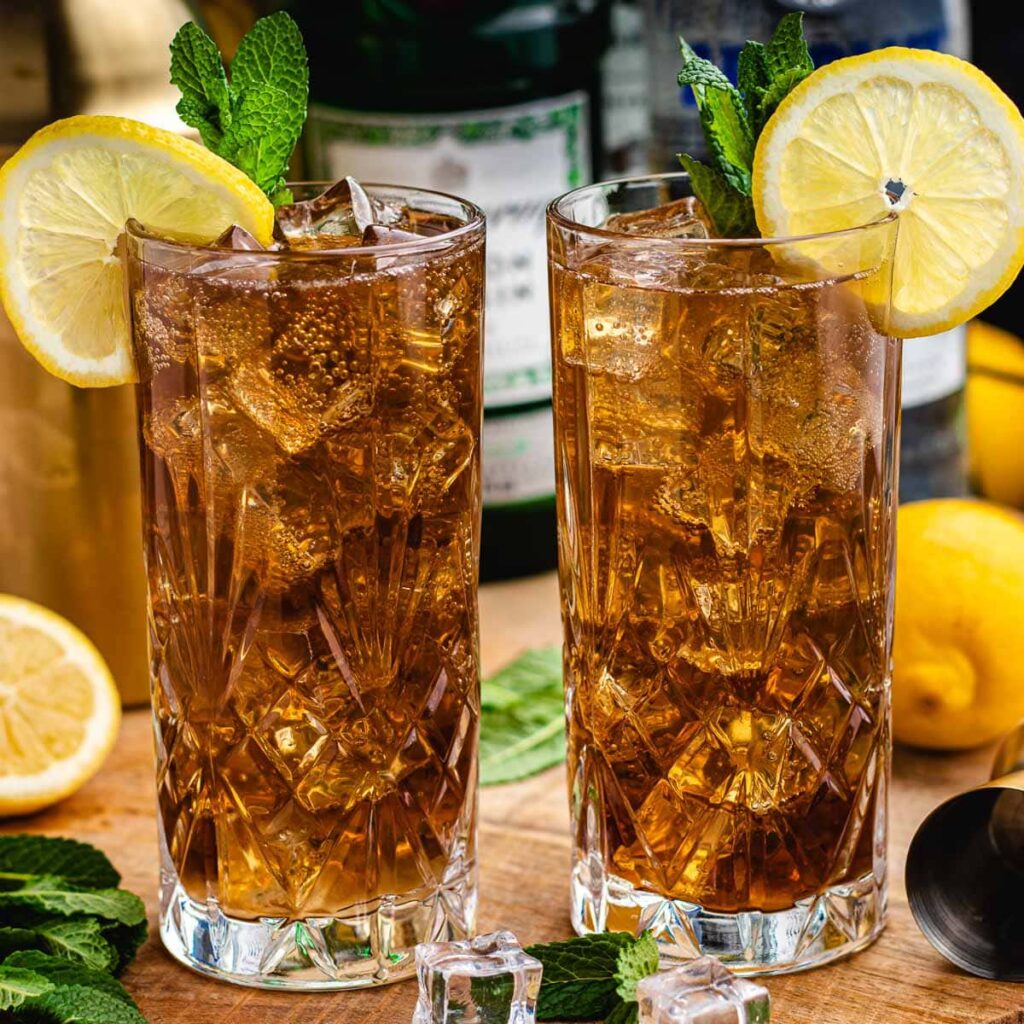 Long Island Iced Tea cocktail with lemon wedge