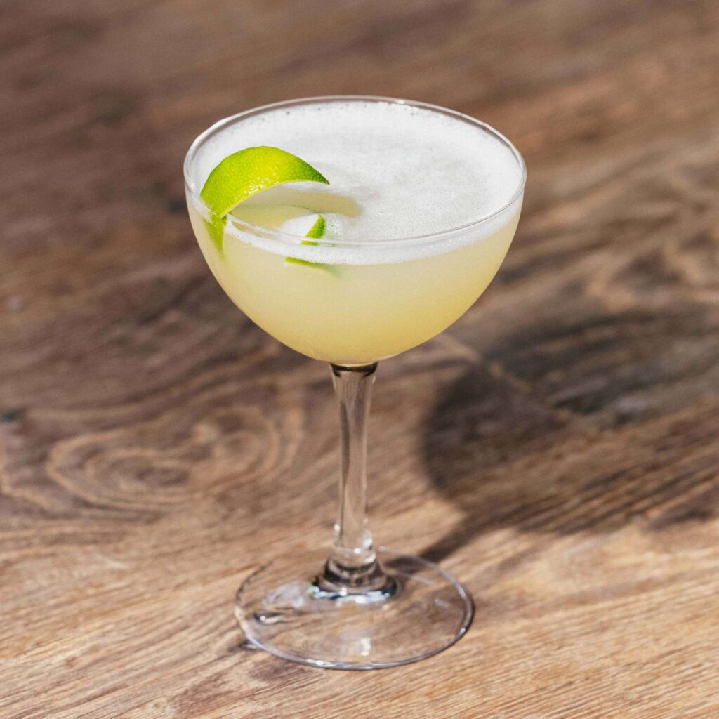 Classic Daiquiri cocktail in coupe glass with lime garnish