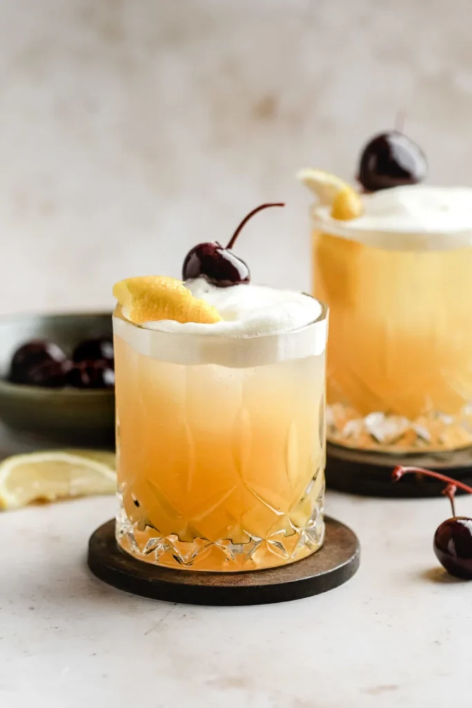 Classic Whiskey Sour cocktail in rocks glass with lemon garnish