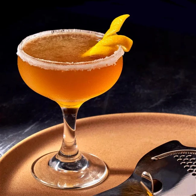 Sidecar cocktail served in a classic coupe glass with a lemon twist