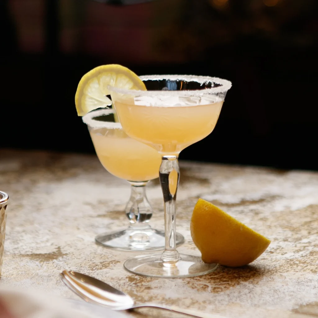 Sidecar cocktail served in a classic coupe glass with a lemon twist