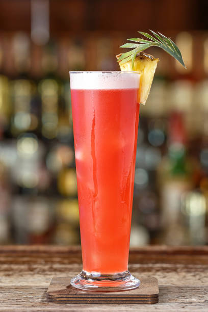 Singapore Sling cocktail with cherry and pineapple garnish