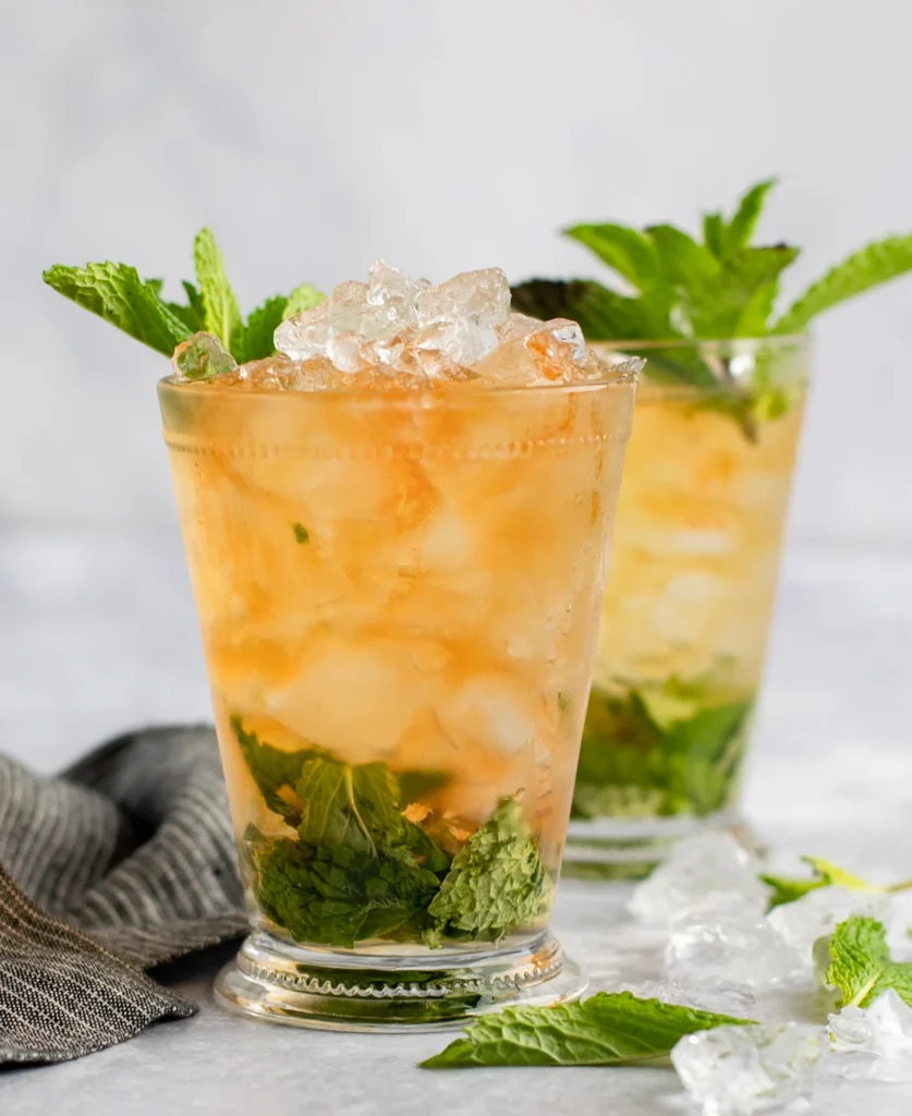 mint julep cocktail served in a silver cup with mint garnish
